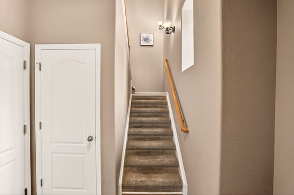 Bright and open staircase leads to spacious upper-level living, enhancing the home's inviting atmosphere.