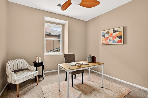 Bright and inviting home office space featuring natural light, modern furnishings, and a cozy atmosphere.