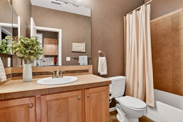 Bright bathroom featuring earthy tones, modern fixtures, and a functional layout for everyday convenience.