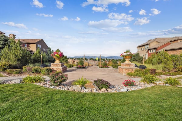 Lush landscaped grounds with vibrant flowerbeds, offering breathtaking mountain views and inviting outdoor spaces.