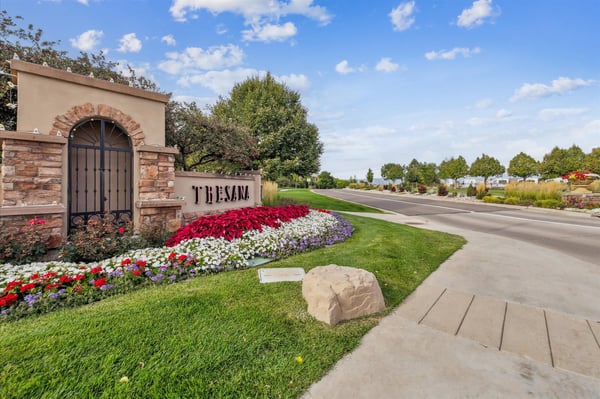 Discover a vibrant community entrance featuring lush landscaping and inviting pathways for easy access.