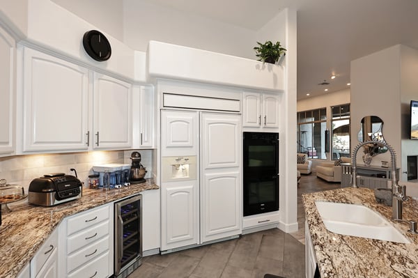Updated Scottsdale kitchen with double ovens, granite counters, custom cabinetry, and wine fridge designed for both entertaining and functionality.