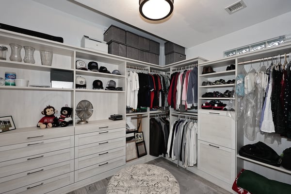 Custom walk-in closet with shelving, drawers, and organized layout maximizes storage in this Scottsdale primary suite.