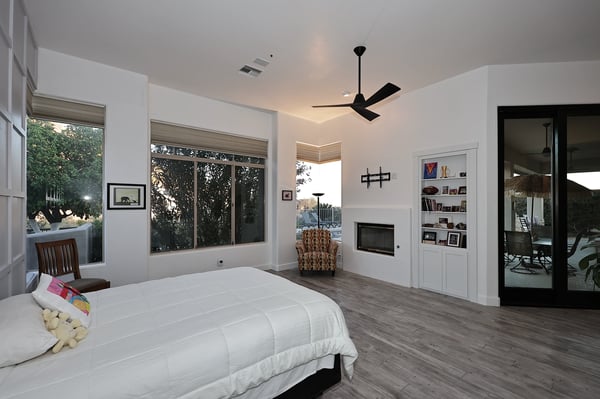 Private primary suite with fireplace, large windows, and outdoor access delivers a relaxing Scottsdale retreat with elegant design.