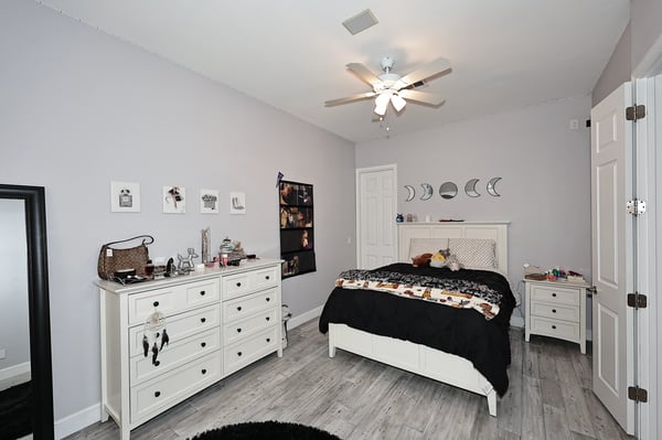Comfortable guest bedroom featuring updated flooring, ceiling fan, and neutral finishes ideal for Scottsdale living and hosting visitors.