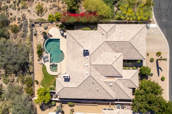 Overhead view of private Scottsdale backyard featuring pool, spa, patio areas, and desert landscaping designed for outdoor entertaining.