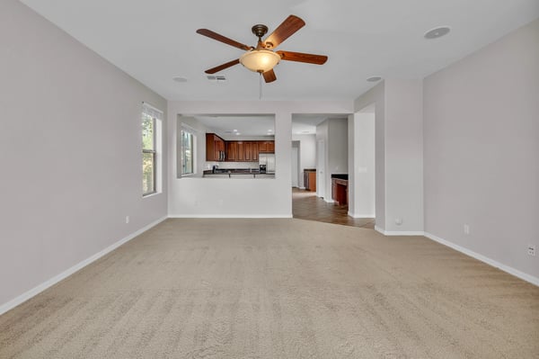 Spacious family room with open layout connecting to the kitchen, perfect for entertaining and modern living.