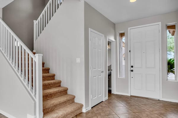 Inviting entryway with tile flooring and staircase access, creating a practical transition into the home's main living areas.