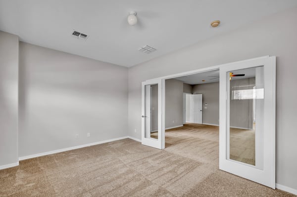 Bonus sitting space off the primary suite with soft carpet and natural light, ideal for a private workspace or quiet relaxation area.