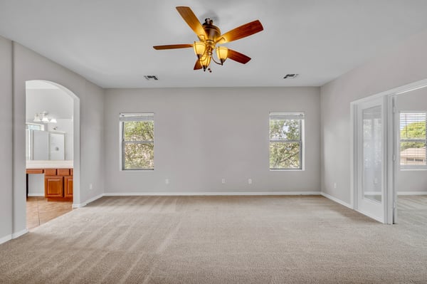 Bright and adaptable bedroom with neutral tones and carpet flooring, offering flexibility for guests, office use, or hobbies.