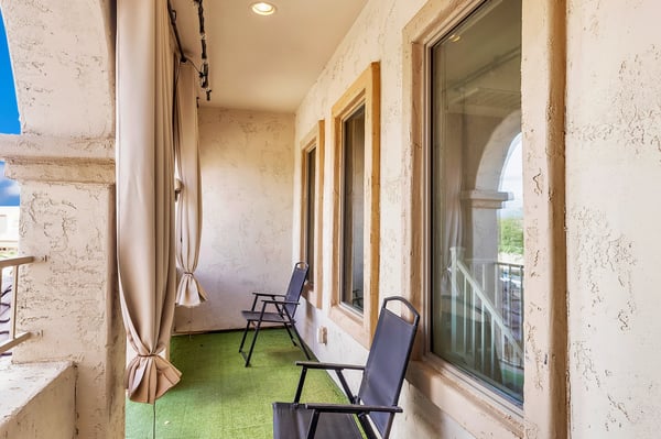 Private covered balcony with seating area, perfect for relaxing outdoors and enjoying the Arizona climate.