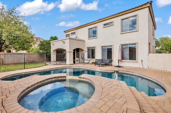 Backyard retreat with integrated spa and pool, offering a perfect space for entertaining and enjoying warm Goodyear evenings.