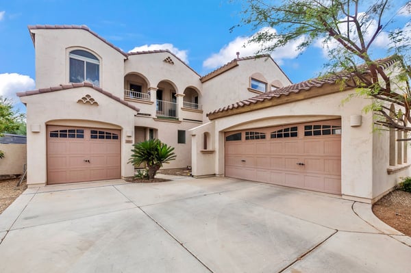 Attractive front elevation with a three-car garage, stucco finish, and spacious driveway, adding both style and functionality in Goodyear.
