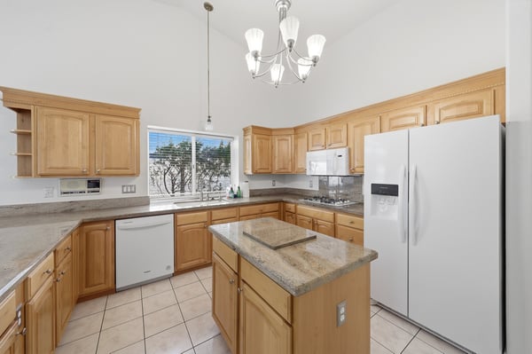 Updated kitchen showcases newer appliances, extensive cabinet storage, and generous counter space designed for both entertaining and everyday convenience.