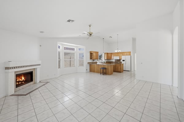 Open kitchen and living spaces with soaring ceilings and tile flooring create an airy, functional layout ideal for entertaining and everyday Arizona living.