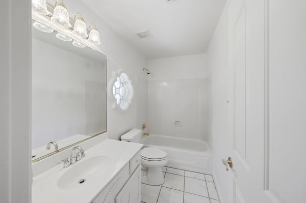 Bright guest bathroom with clean finishes, full shower and tub combination, and spacious vanity adds comfort and convenience for family and visitors.