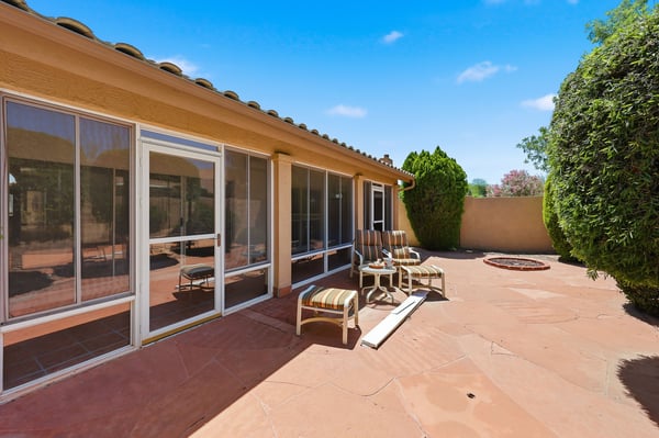 Expansive patio and enclosed Arizona room provide versatile indoor-outdoor living space perfect for entertaining guests or relaxing in privacy year-round.