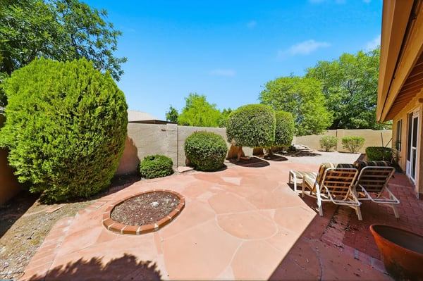 Beautiful low-maintenance backyard with mature landscaping and spacious patio areas creates a peaceful outdoor retreat in this desirable Peoria home.