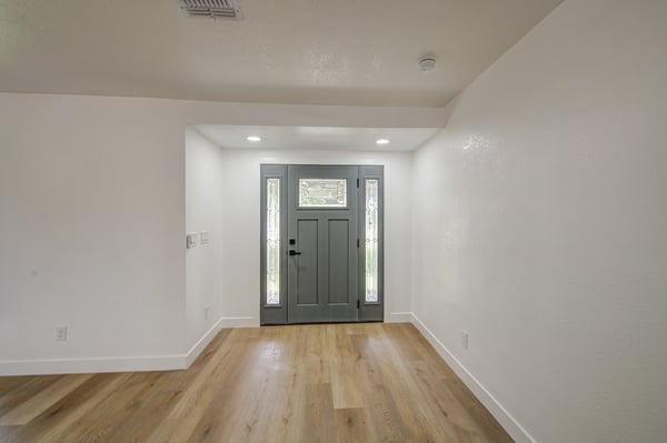 Modern finishes, new flooring, updated trim, and abundant natural light create an elegant entry that welcomes family and guests into this beautifully renovated home.