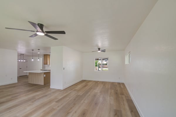 This spacious living room provides endless possibilities for entertaining or relaxing, enhanced by updated finishes, fresh paint, and beautiful natural light.