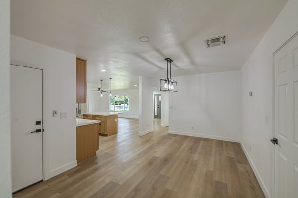 Spacious and filled with modern appeal, the dining room features updated flooring, designer lighting, and an open layout that enhances everyday comfort.
