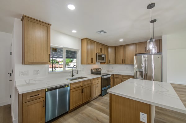 Thoughtfully remodeled with 42-inch white oak cabinetry, quartz countertops, stainless steel appliances, and a spacious island, this kitchen blends beauty with everyday functionality.
