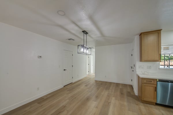 Contemporary lighting, fresh finishes, and an open floor plan make this dining room a welcoming space for casual meals, holiday gatherings, and everyday living.