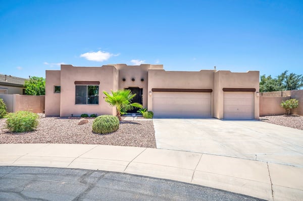 Attractive front elevation featuring classic Southwest architecture, desert landscaping, and an inviting entryway. This Palm Valley home in Goodyear offers exceptional curb appeal, seller-owned solar, and a spacious 3-car garage.