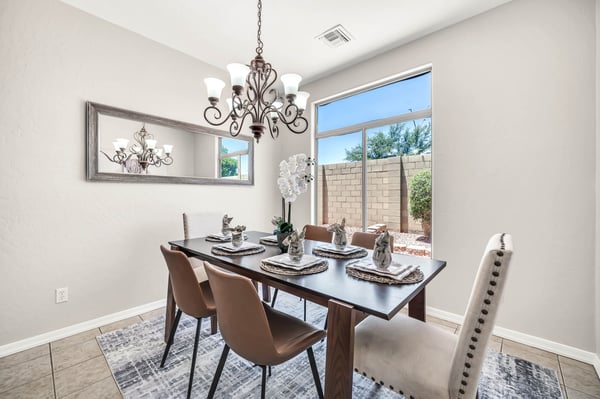 Light-filled dining room featuring modern lighting, oversized windows, and ample room for hosting family meals and special occasions. Conveniently located adjacent to the kitchen for effortless entertaining.