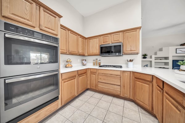 Functional kitchen equipped with a gas cooktop, double wall ovens, extensive cabinetry, and generous prep space. Designed for home chefs who appreciate both style and efficiency.