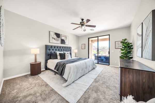 Bright primary suite with direct access to the covered patio for enjoying Arizona mornings and evenings. The spacious layout offers privacy and easy access to the backyard retreat with pool and waterfall.