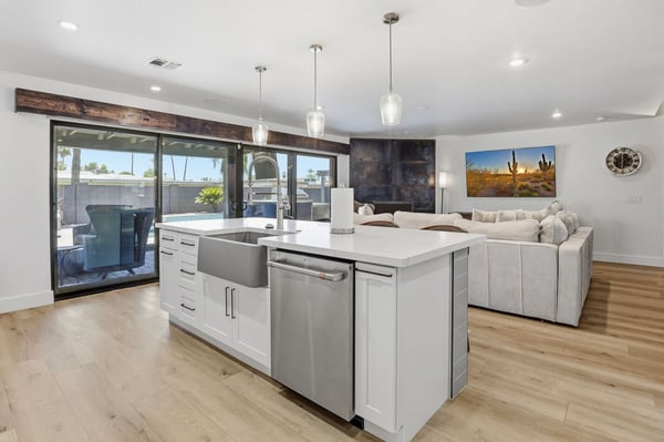 Modern kitchen opens seamlessly to the great room, featuring quartz countertops, an oversized island, farmhouse sink, and premium finishes ideal for entertaining and everyday comfort.