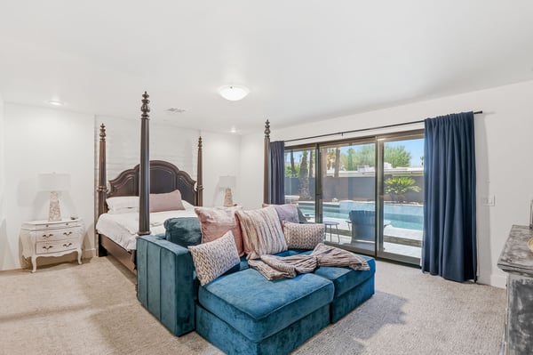 Relax in the spacious primary bedroom featuring pool views, generous natural light, and direct backyard access. A peaceful retreat designed for comfort and everyday luxury.