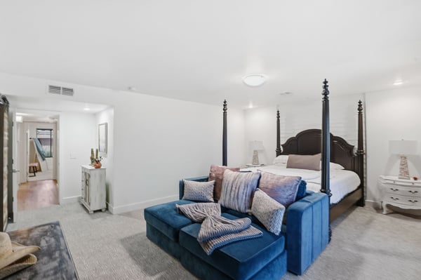 Spacious primary bedroom features comfortable sitting space, elegant finishes, generous proportions, and convenient access to the luxurious ensuite and walk-in closet.