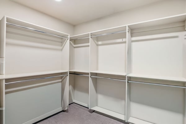 Well-designed walk-in closet provides extensive shelving, hanging space, and organization, complementing the spacious primary suite with practical everyday storage.
