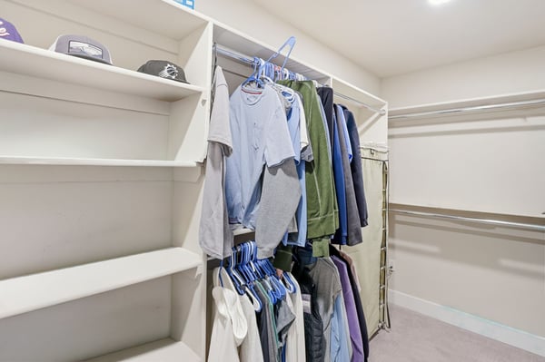Large walk-in closet provides built-in shelving, hanging areas, and organized storage solutions, complementing the beautifully designed primary suite.