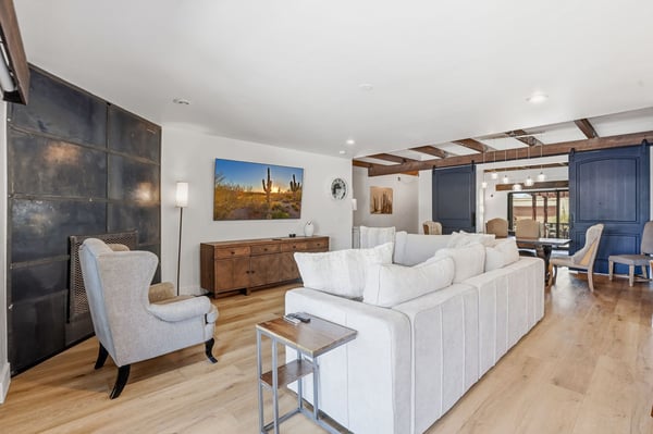Comfortable family room highlights a stylish fireplace, open-concept layout, luxury flooring, and easy access to the dining room, creating an ideal space for gathering and entertaining.
