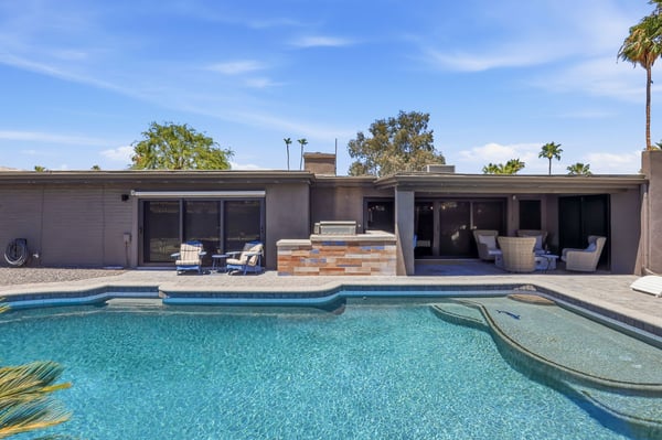 Spacious backyard combines a sparkling pool, covered patio, outdoor kitchen, and multiple seating areas for effortless Scottsdale entertaining and everyday outdoor enjoyment.