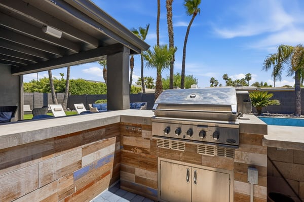 Built-in grilling station offers premium outdoor cooking, generous serving space, and convenient access to the covered patio and pool, creating the perfect Scottsdale entertaining hub.