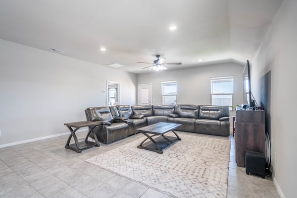 Spacious living area featuring a large sectional sofa, perfect for entertaining or relaxing with family.