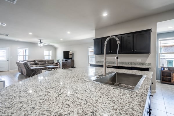 Spacious open-concept living area features modern finishes and a large island, perfect for entertaining.