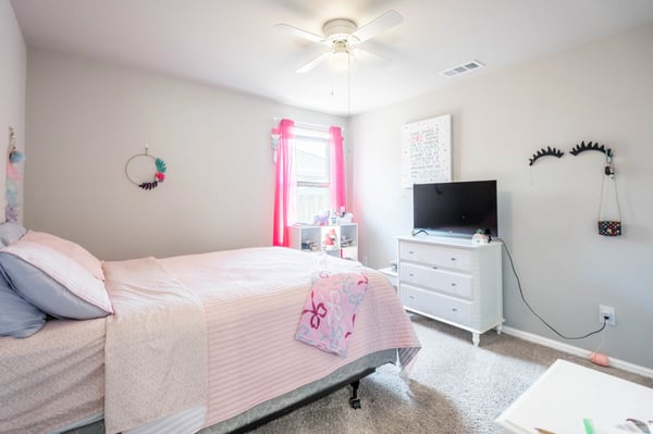 Bright and inviting bedroom featuring a cozy atmosphere, modern amenities, and abundant natural light.