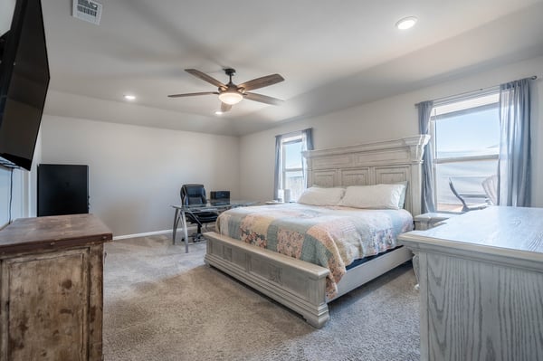 Spacious bedroom featuring modern amenities, natural light, and a comfortable layout for relaxation and productivity.
