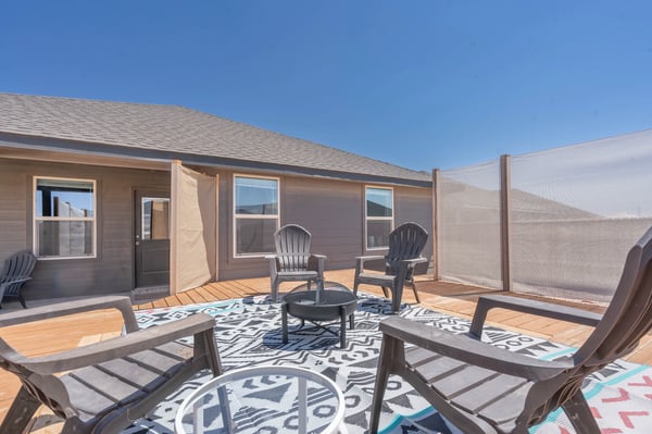 Spacious outdoor patio area with seating, perfect for gatherings and enjoying sunny days.