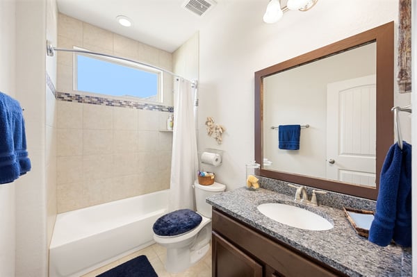 This modern bathroom features contemporary fixtures, a spacious tub, and a well-lit vanity area.