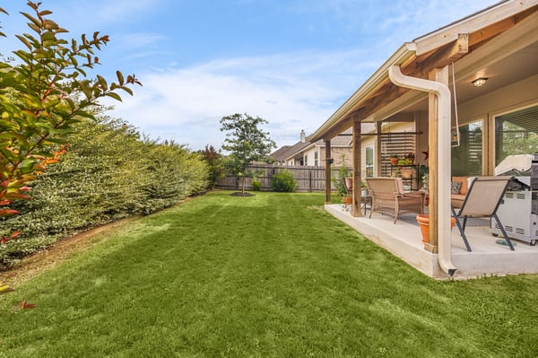 Spacious backyard perfect for outdoor gatherings, featuring well-maintained landscaping and covered patio area.