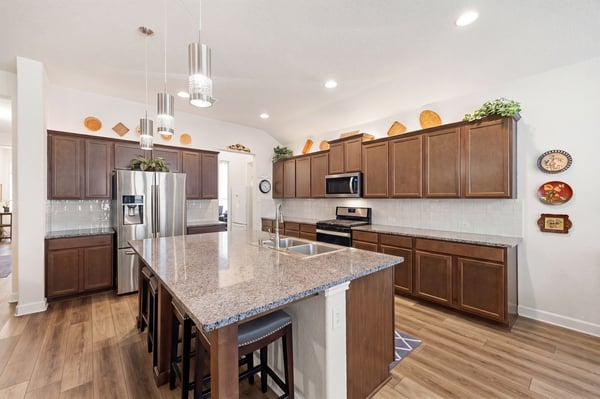 Spacious kitchen featuring modern appliances, ample counter space, and an inviting island perfect for gatherings.