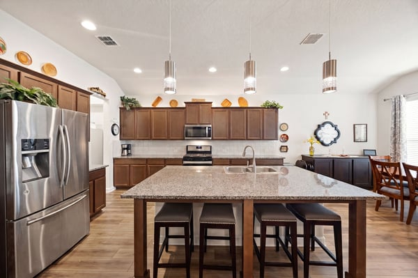 Spacious kitchen featuring modern appliances, granite countertops, and a large island, perfect for entertaining.