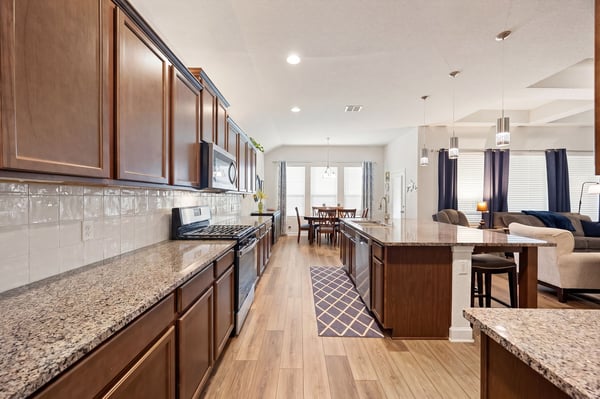 Modern kitchen featuring ample counter space, stainless steel appliances, and a seamless flow to the dining area.