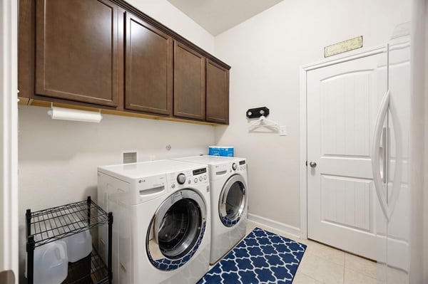 Spacious laundry room featuring modern appliances, ample storage, and practical design for efficient household management.